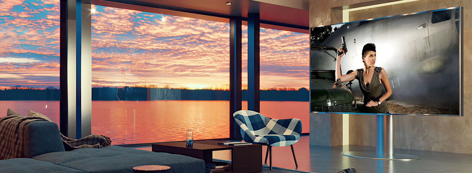 Living room in Bahrain with a spacious couch facing a large Smart TV and sunset view.